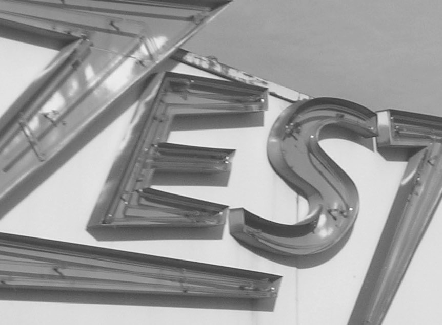 photograph of a neon sign that reads zest
